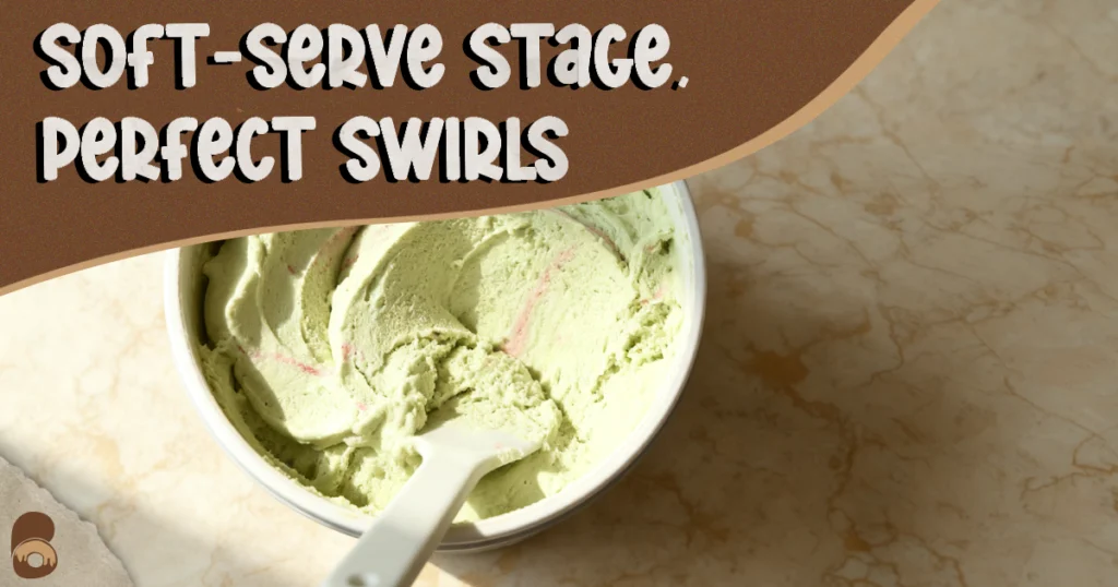 45-degree view of strawberry matcha ice cream in the machine at soft-serve stage with visible swirls